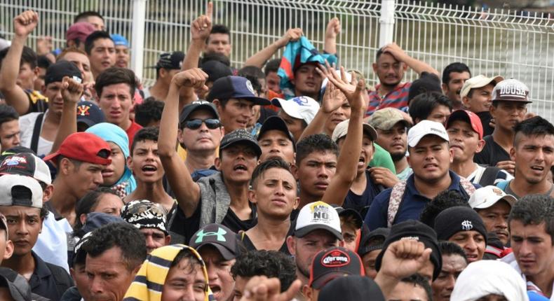 Honduran migrants in a caravan heading to the US arrive at the border crossing point with Mexico, in Ciudad Tecun Uman, Guatemala, on October 19, 2018