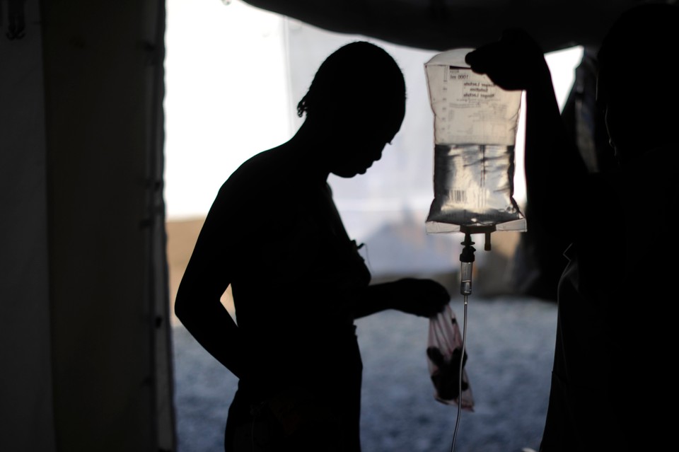 A woman infected with cholera receive treatment in a clinic set up by the aid agency Medecins Sans Frontieres (MSF) Port-Au-Prince