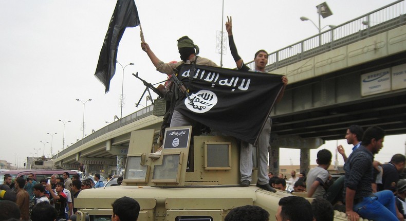 ISIS fighters parade in the streets of Fallujah, Iraq in March 2014.