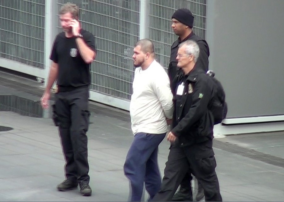 Brazilian federal police officers escort one of the 10 people they arrested on suspicions of ties to Islamic State in Sao Paulo.
