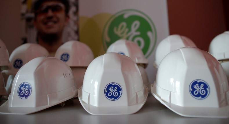 The General Electric logo is pictured on working helmets