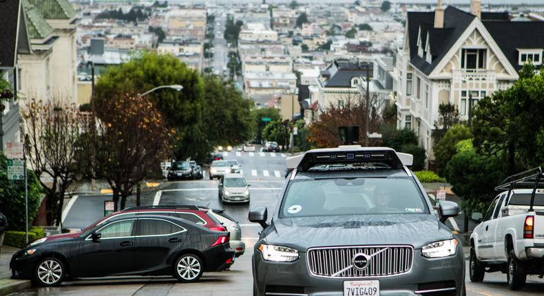 An Uber self-driving vehicle climbs a hill in San Francisco.