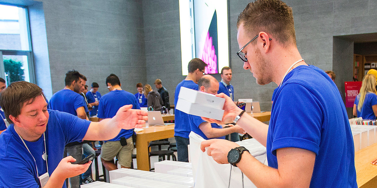 Apple employees prepare the newly released iPhone 6 for sale at the Apple store in Berlin September 19, 2014.