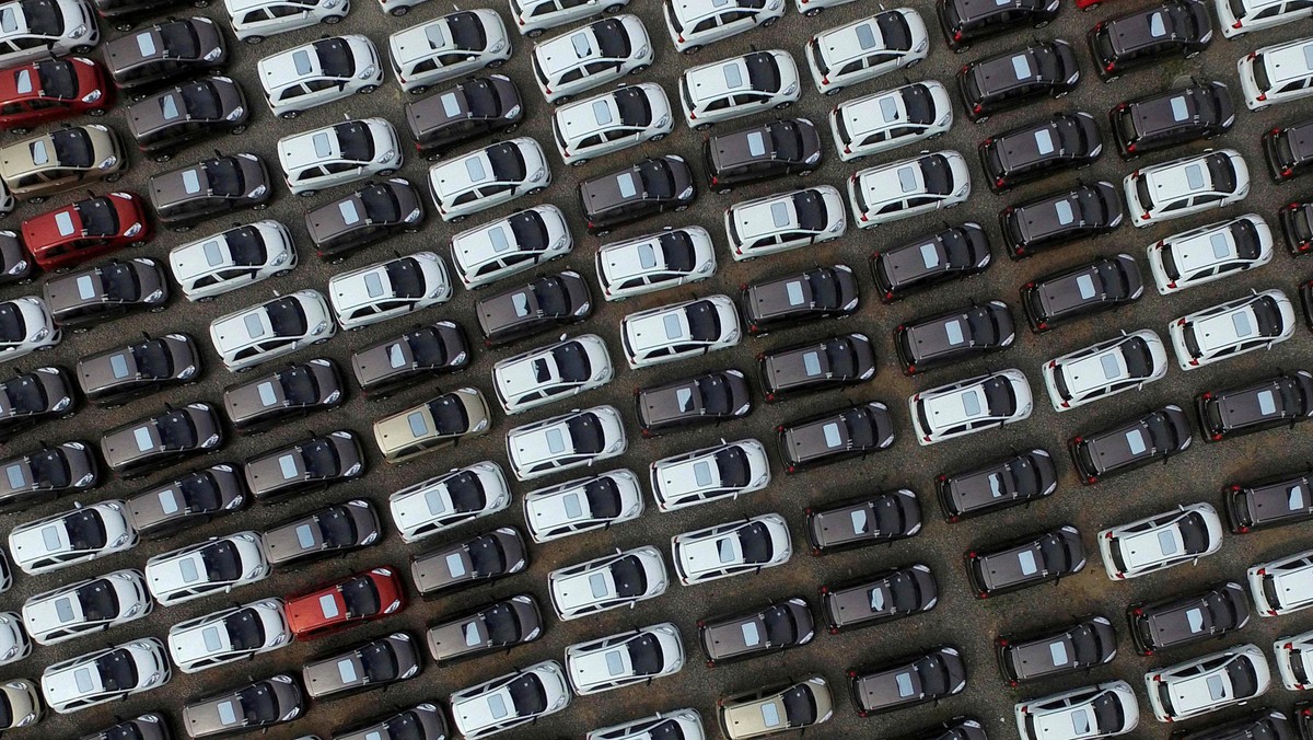 FILE PHOTO: Electric cars are seen at a parking lot of an automobile factory in Xingtai, Hebei provi