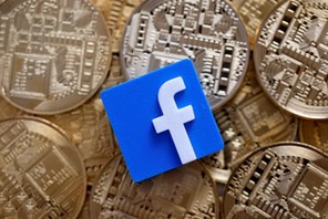 FILE PHOTO: Facebook logo is seen on representations of Bitcoin virtual currency in this illustration picture