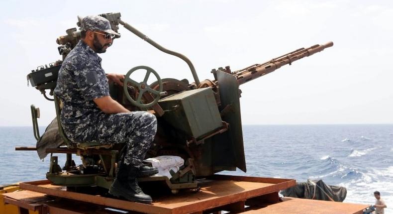 A member of the Libyan coastguards mans a machine gun on a patrol boat off the coast of Misrata on May 9, 2015