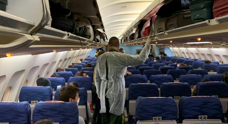 French citizens board an evacuation plane in Wuhan on Thursday night