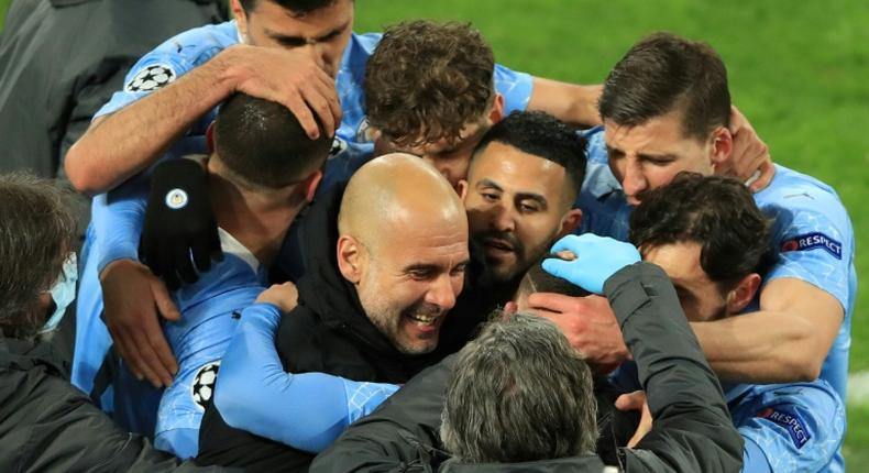 Pep Guardiola (C) celebrates with his Manchester City team in Dortmund