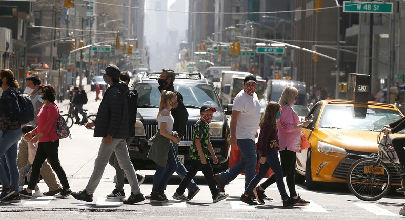 Pedestrians cross 6th Avenue in Midtown, New York City.
