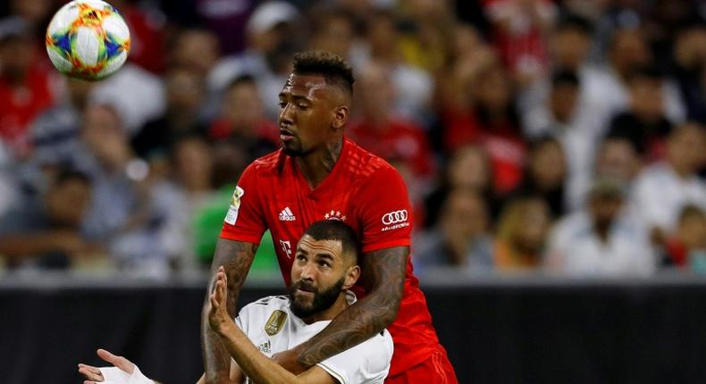 Real Madrid forward Karim Benzema (L) and Bayern Munich defender Jerome Boateng fight for the ball during Bayern's 3-1 friendly victory in Houston, Texas