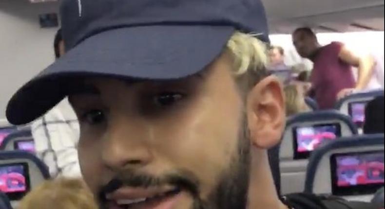 Screenshot of a video taken by Adam Saleh shows him being removed from a Delta flight.