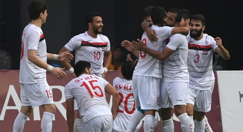 Syria football players celebrate after scoring against Palestine at the Asian Games in Indonesia on August 23, 2018