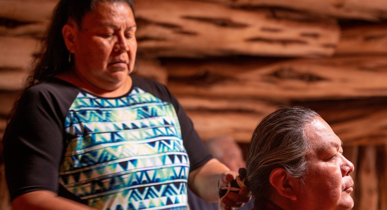 Navajo woman helping her husband braid his hairgrandriver/Getty Images