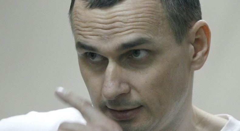 Ukrainian film director Oleg Sentsov looks out from a defendants' cage as he listens to the verdict at a military court in the southern city of Rostov-on-Don on August 25, 2015