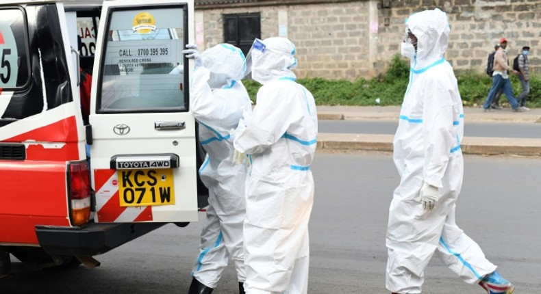 File image of medics handling a Covid-19 case in Kenya