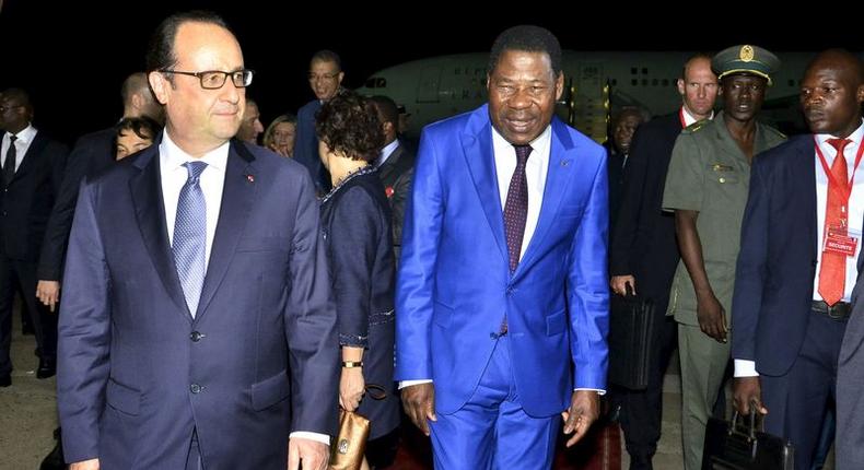 French President Francois Hollande (L) walks with Benin President Thomas Yayi Boni after landing in Cotonou, Benin, July 2, 2015. REUTERS/Charles Placide Tossou