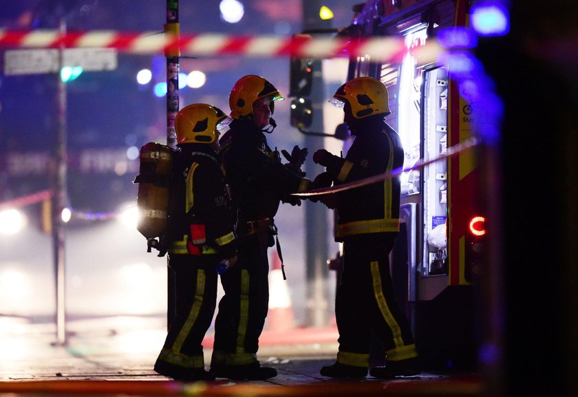 Firefighters spray water onto a fire at Camden Market in London