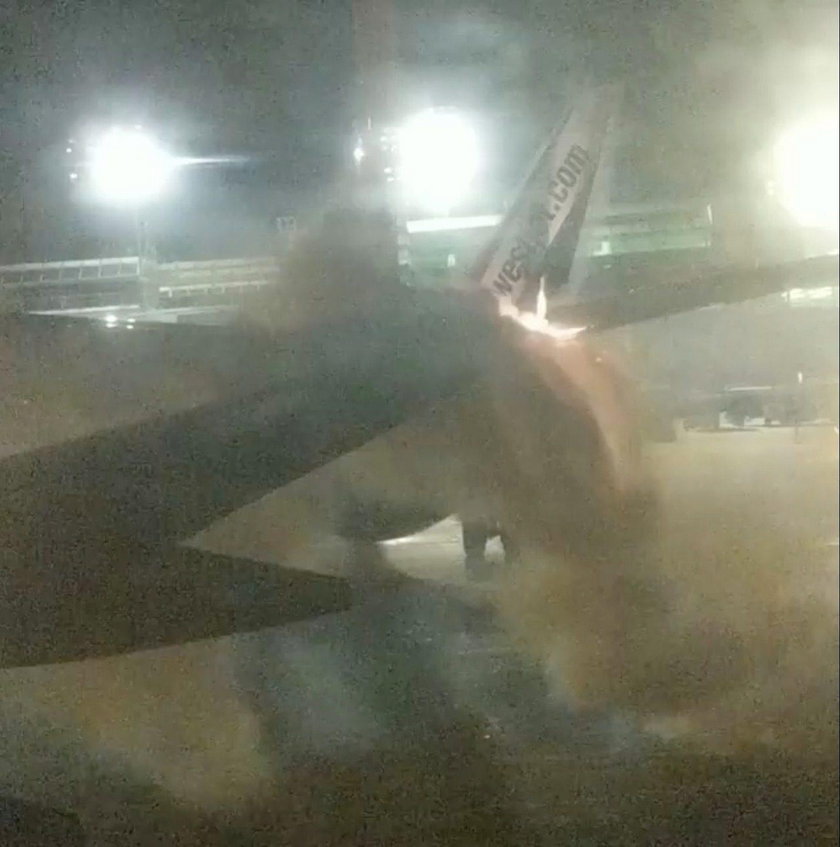 An explosion is seen through a window of a plane that has collided with another plane at Toronto's P