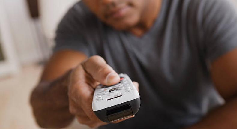 A man holding a remote control