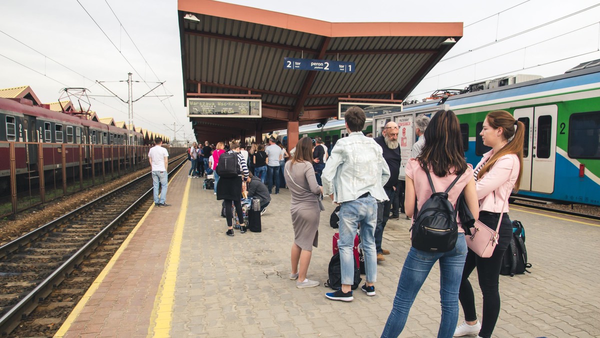 Many people with Luggage on the platform waiting for the delayed train