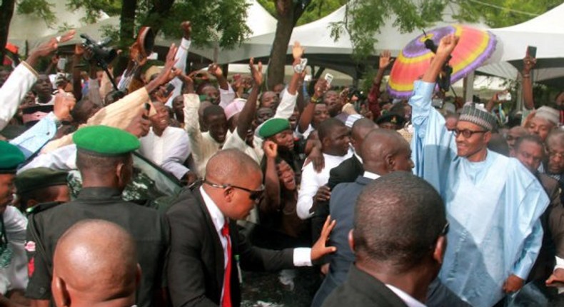 Excited youths surround President Muhammadu Buhari in Abuja on July 17, 2015.