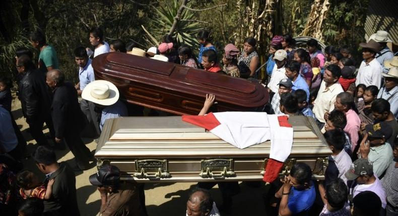 Thousands of indigenous Guatemalans accompany to the cemetery the coffins of two children killed by their kidnappers in the Cerro Alto village in San Juan Sacatepequez, 45km west of Guatemala city on February 14, 2017