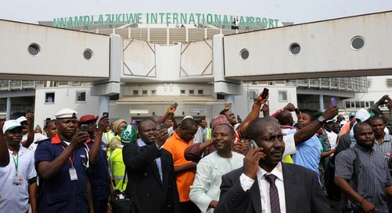 People wait for relatives at Nnamdi Azikiwe International Airport in Abuja, Nigeria
