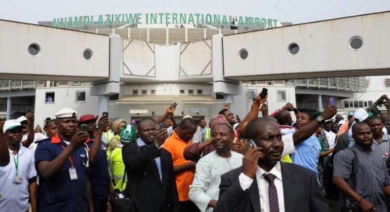 People wait for relatives at Nnamdi Azikiwe International Airport in Abuja, Nigeria