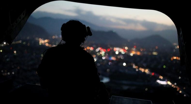 A US Army serviceman sits at the tailgate of an helicopter. The Afghan Taliban announce the start of their spring offensive, saying they would target foreign forces in their country.