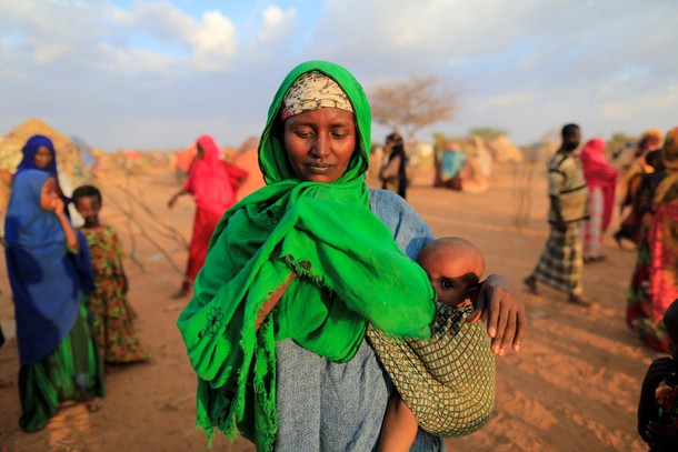 An internally displaced woman from drought hit area reacts after she complains about the lack of foo