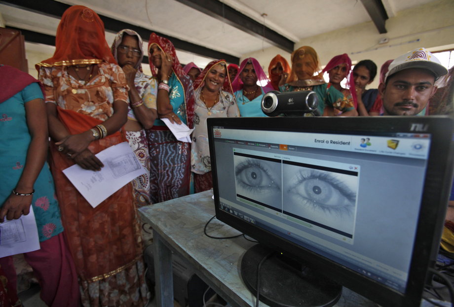 Village women stand in a queue to get themselves enrolled for the Unique Identification (UID) database system at Merta district in the desert Indian state of Rajasthan.