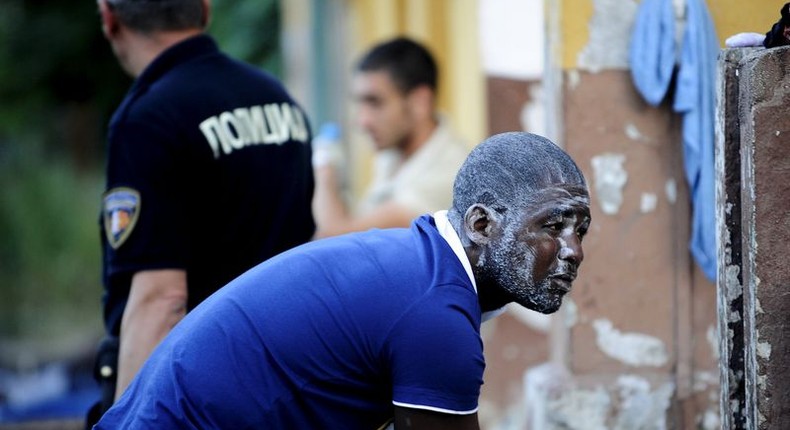 A migrant washes himself at a train station in Demirkapija near the Greek border June 17, 2015. REUTERS/Ognen Teofilovski