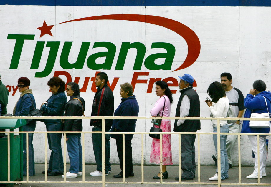 People wait in line to cross the border between Mexico and the US in Tijuana, Mexico, May 6, 2006.