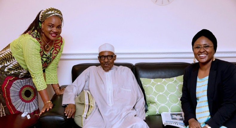 In this handout photograph taken and released by The Nigerian State House on July 26, ailing Nigerian President Muhammadu Buhari (C) poses with his wife Aisha Buhari (R) and the wife of Benue State Governor Eunice Ortom as he received a courtesy visit delegation at Abuja House in London