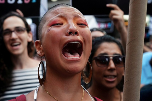 A participant cries during a protest against U.S. President Donald Trump's announcement that he plan