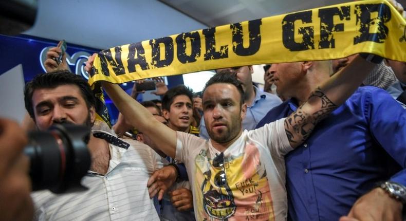 French football player Mathieu Valbuena (C) is greeted by fans as he arrives at Ataturk International airport in Istanbul, Turkey in June