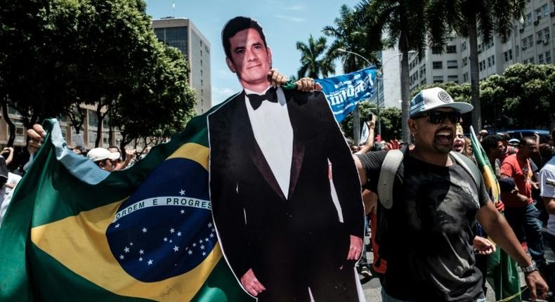 A protester carries a life-size image of Brazilian Federal Judge Sergio Moro, who conducts the Lava Jato probe, the biggest corruption investigation in the nation's history, during a public servants' demo in Rio de Janeiro, on December 12, 2016