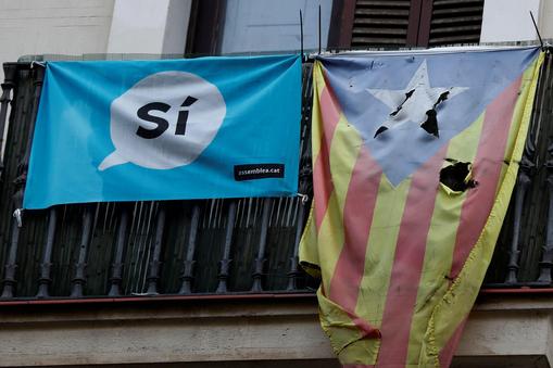 A damaged Estelada (Catalan flag of independence) hangs from a balcony in Barcelonae