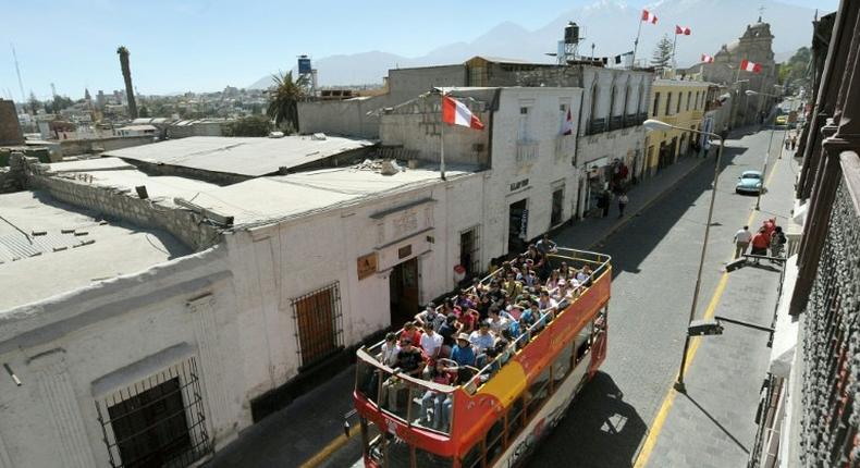 Tourists ride on a sightseeing bus in Arequipa, 1,600 km south of Lima