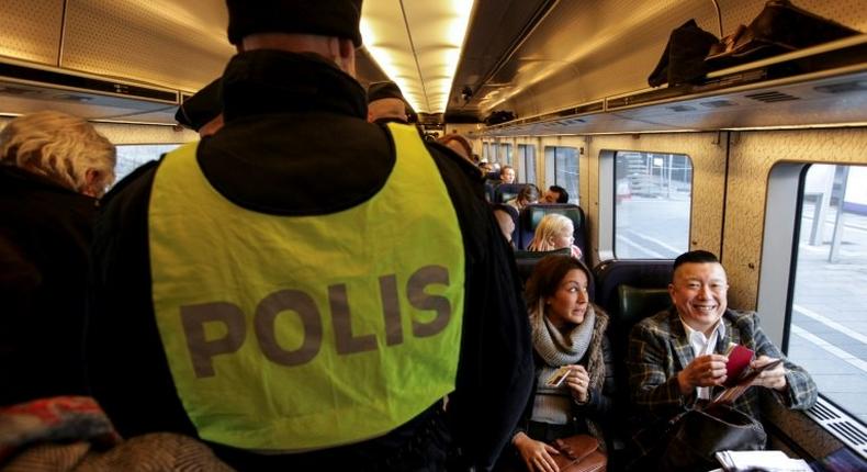 Swedish police carry out identity checks on the train from Copenhagen, Denmark, to Malmo, Sweden, on November 12, 2015