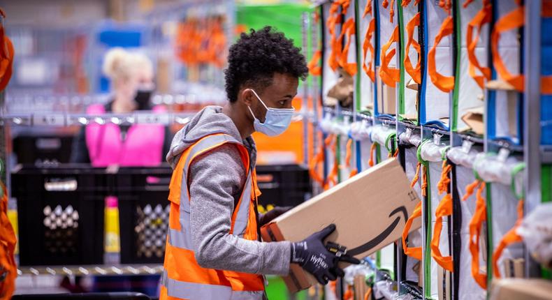 Employees sort parcels from online retailer Amazon at a distribution center.Jens Bttner/picture alliance via Getty Images