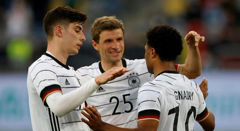 Kai Havertz (L) and Thomas Mueller (C) celebrate with Germany goalscorer Serge Gnabry in a Euro 2020 warm-up win over Latvia Creator: Odd ANDERSEN