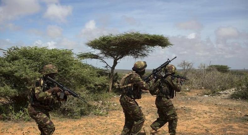 Kenya Defence Forces (KDF) Rangers, who are part of the African Mission in Somalia (AMISOM), secure an area during a foot patrol on the outskirts of the controlled area of the old airport in the coastal town of Kismayu in southern Somalia November 12, 2013. REUTERS/Siegfried Modola