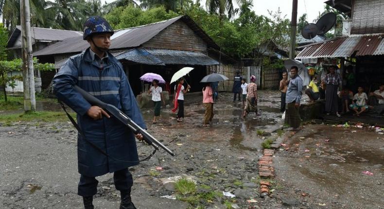 An armed policeman stands guard during a visit of former UN secretary general Kofi Annan to the Aung Mingalar displacement camp for the minority Muslim Rohingya, in Sittwe, Myanmar in September 2016