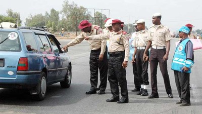 Officers of the  Federal Road Safety Corps (FRSC) stopping a vehicle.