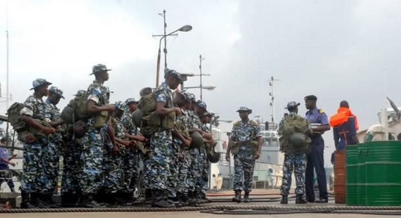 Naval officers receiving instructions from their superior.