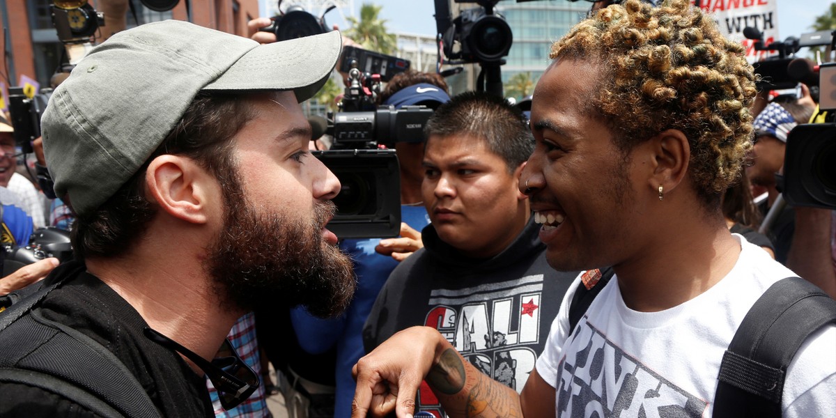 A Trump supporter (left) debates with a demonstrator opposed to Republican US presidential candidate Donald Trump, before Trump's campaign event, in San Diego, California, on May 27.