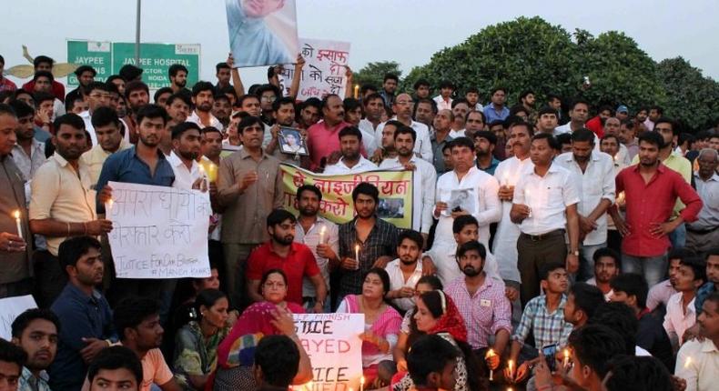 People gather for a vigil for a teenage boy who died of a suspected drug overdose in Greater Noida