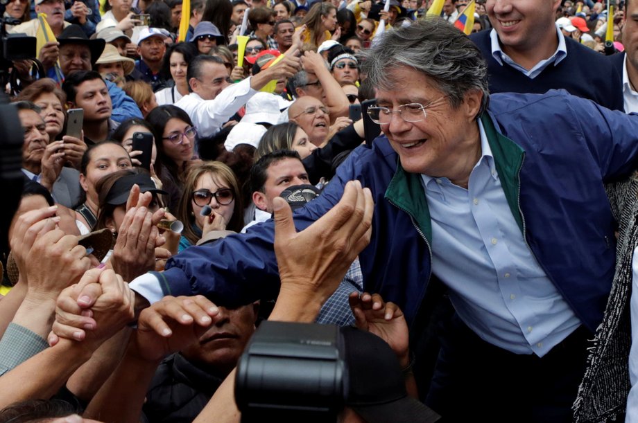 Supporters of Guillermo Lasso, presidential candidate from the CREO party and other opposition supporters stand outside the electoral council (CNE) headquarters, in Quito, Ecuador, February 21, 2017.