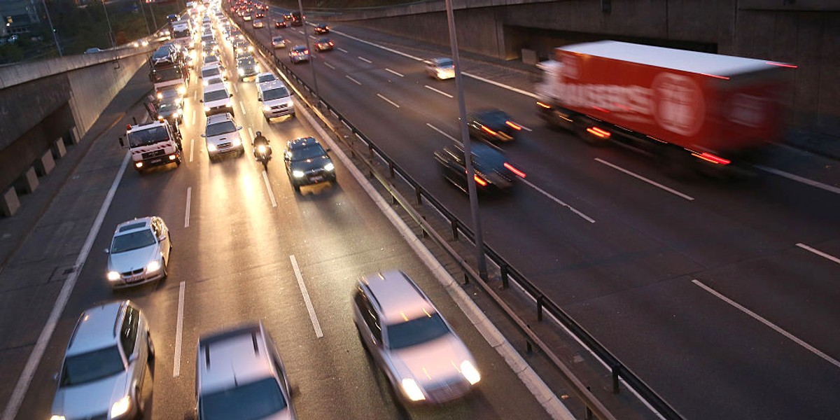 Cars and traffic fill the A100 ring highway in Berlin, Germany.